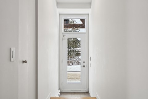 A white door with a glass window in the middle.