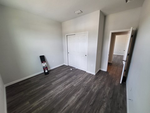 a living room with wood flooring and a white door