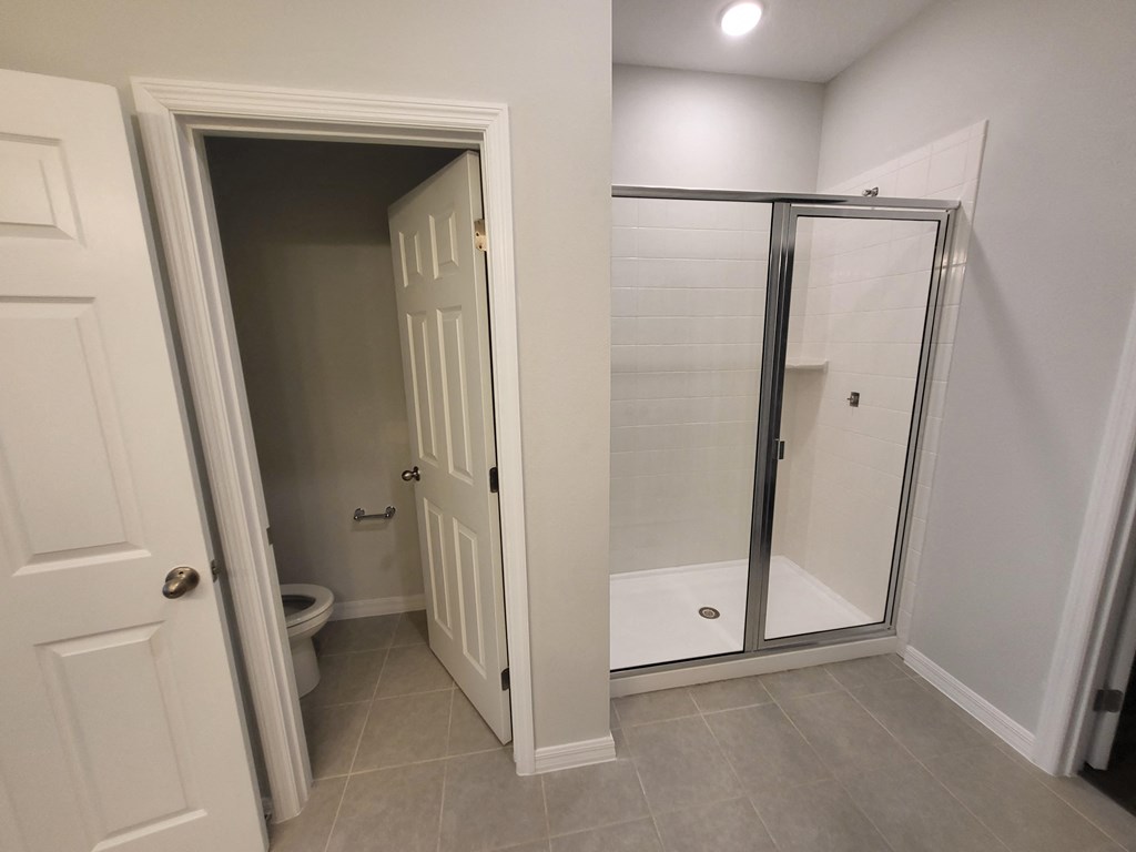 a small bathroom with a shower and toilet