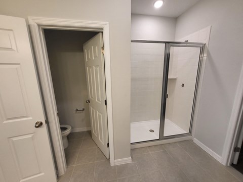 a small bathroom with a shower and toilet