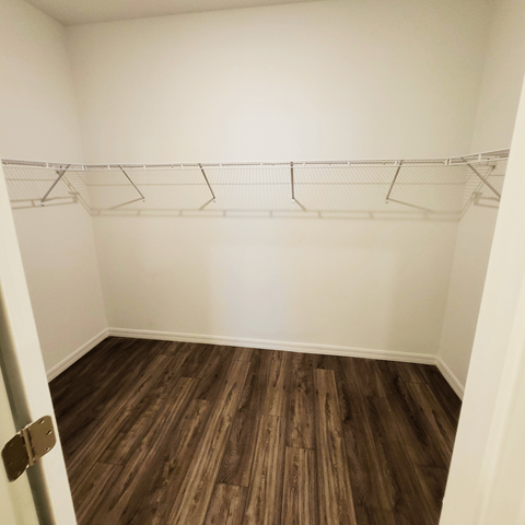 an empty room with white walls and a wooden floor