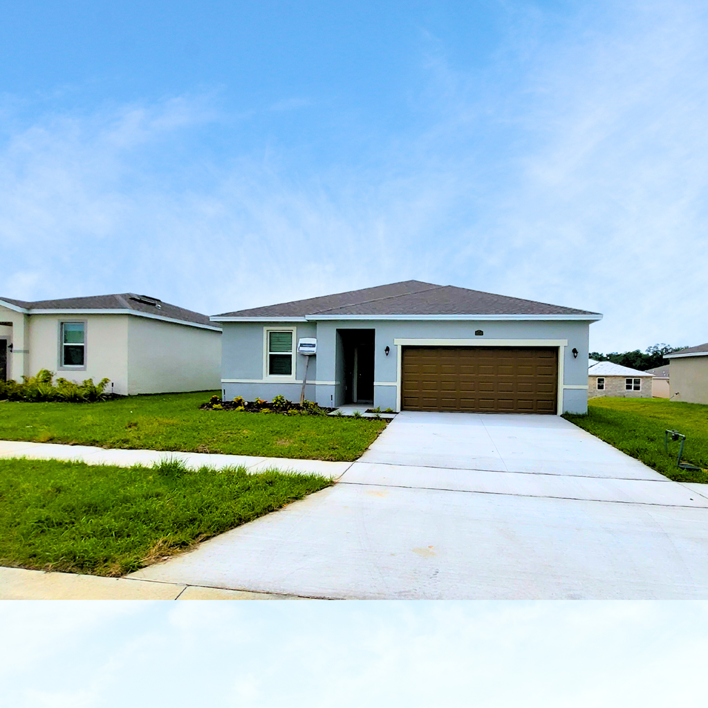 a white house with a brown garage door