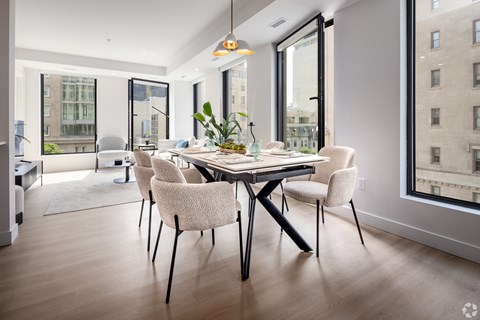 A dining room with a table and chairs.