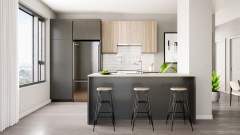 A modern kitchen with a bar stool in front of the island.