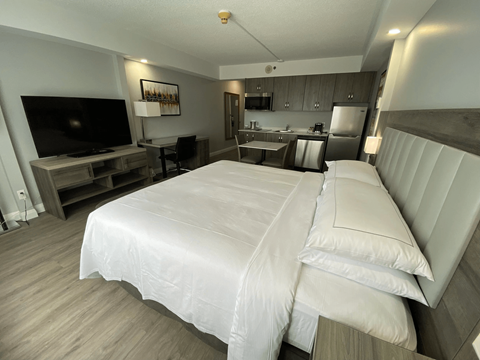 A bedroom with a large bed and a television.