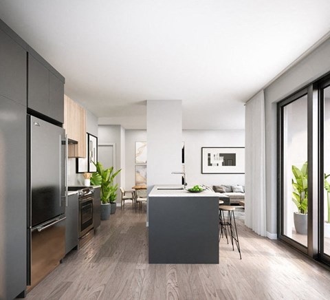 A modern kitchen with a refrigerator, oven, and sink.