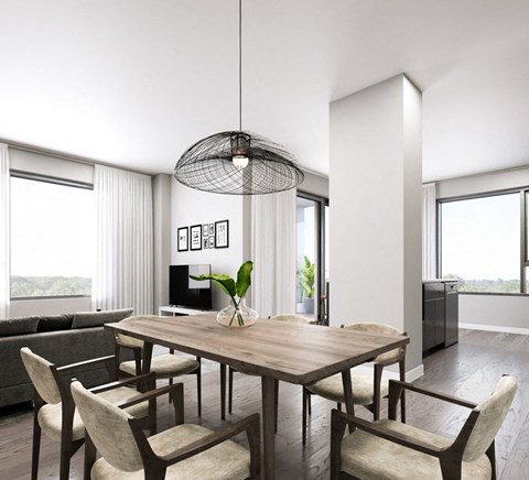 A modern dining room with a wooden table and chairs.