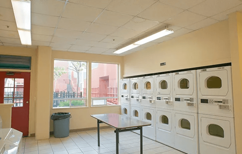 A laundry room with a table and washing machines.