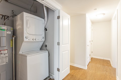 A white washer and dryer are in a small utility room.