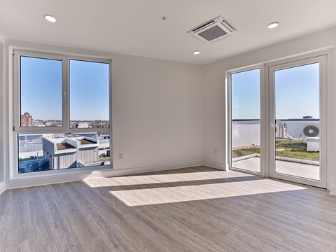 A room with a view of the city through large windows.
