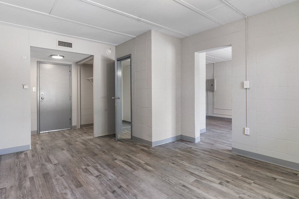 an empty room with white walls and a wooden floor