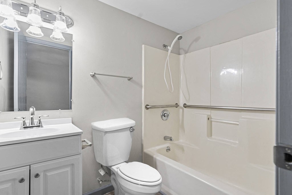 a white bathroom with a toilet sink and shower
