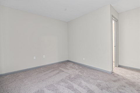 an empty room with carpet and a door
