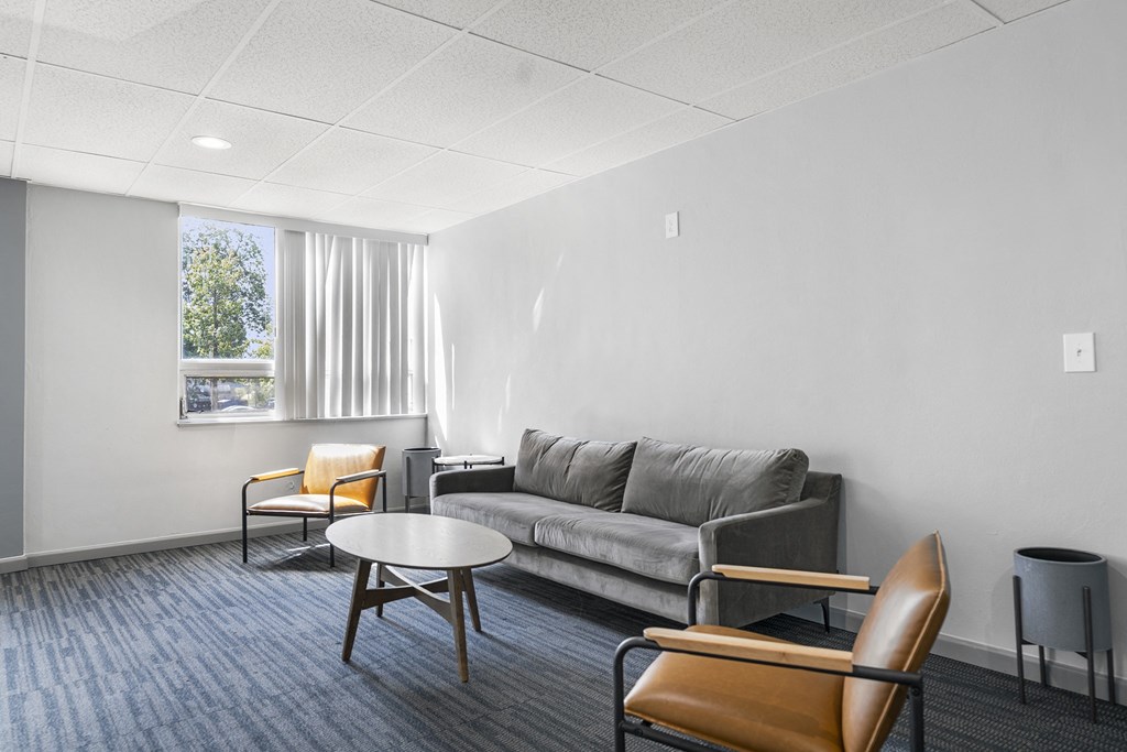 a living room with a couch and chairs and a table