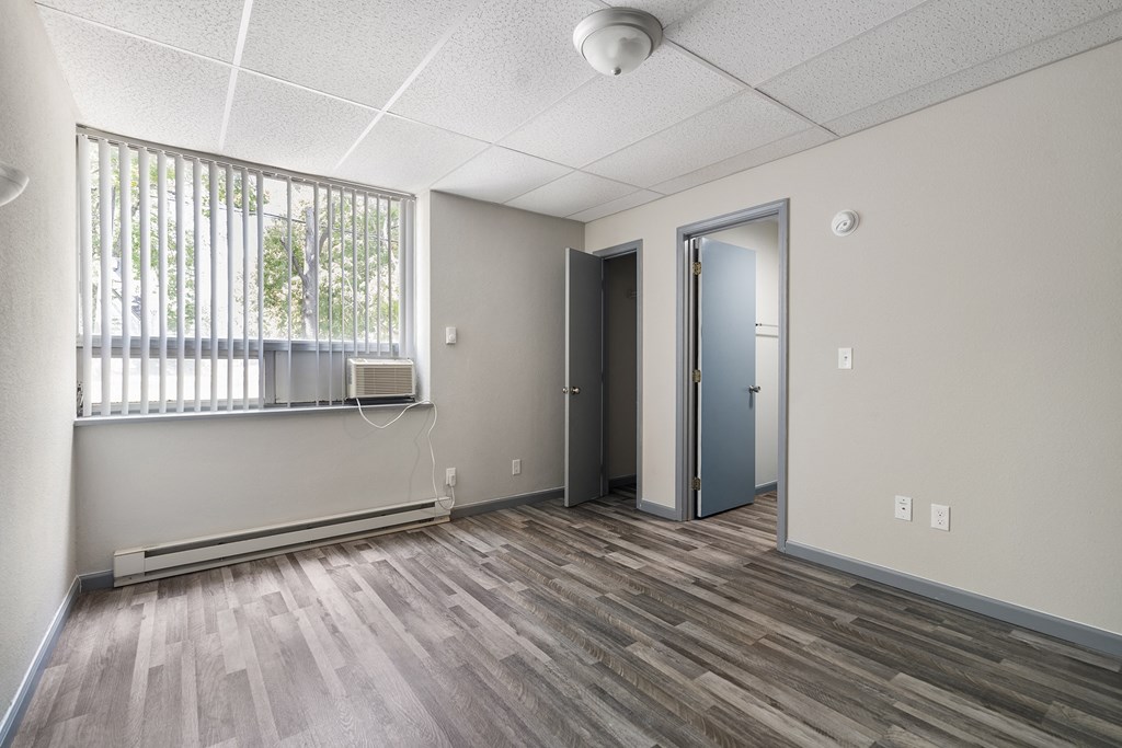 an empty room with a window and a door