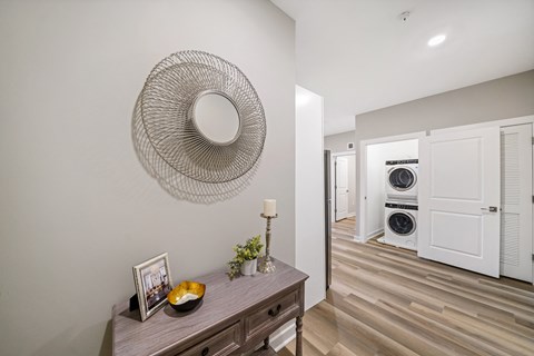 Entryway with view of in-unit washer and dryer