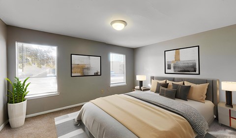 A bedroom with a large bed and two framed pictures on the wall.