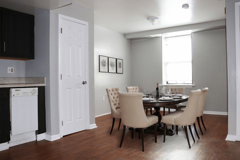 a dining room and kitchen with a table and chairs