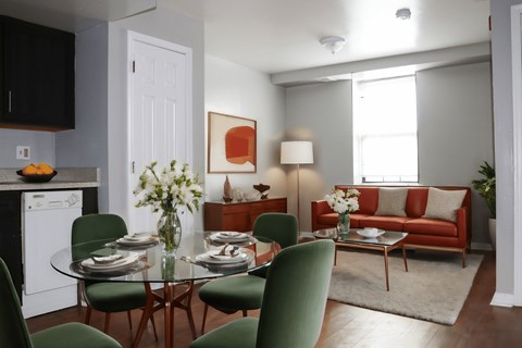 a living room and dining room with a table and chairs
