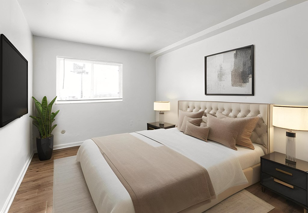 a bedroom with a large bed and a tv