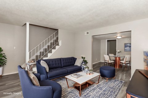A living room with a blue couch and a coffee table.