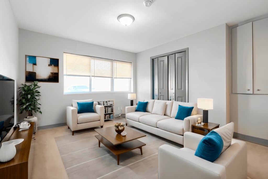 a living room with couches and chairs and a table