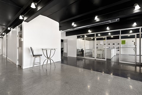a large room with a table and chairs in the middle of it