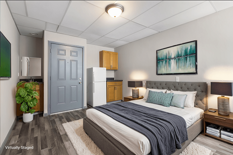 A bedroom with a bed, nightstands, and a painting on the wall.