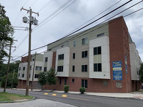 A brick building with a sign that says "Wholesale Court" on it.