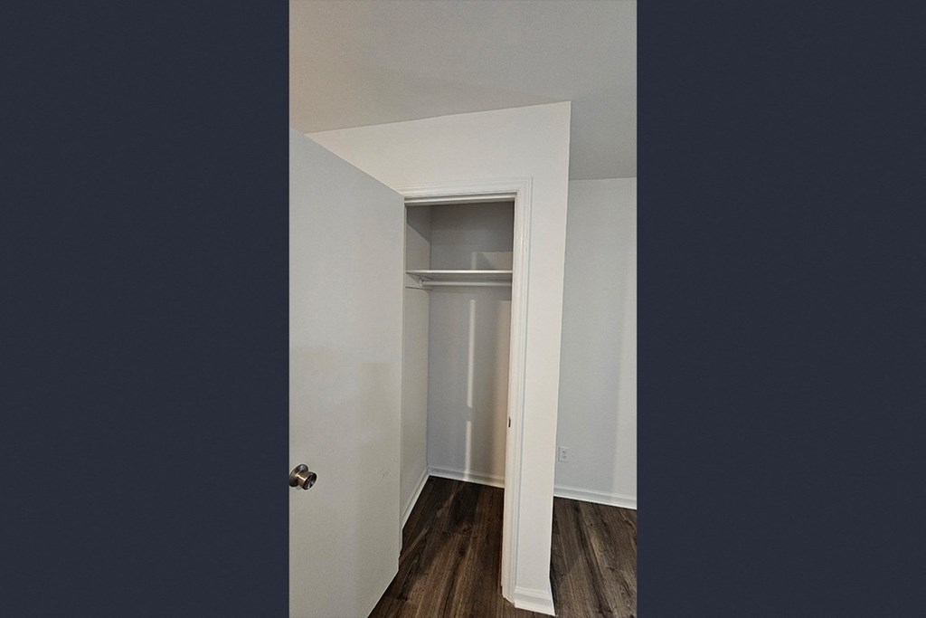a closet in a small room with a door open