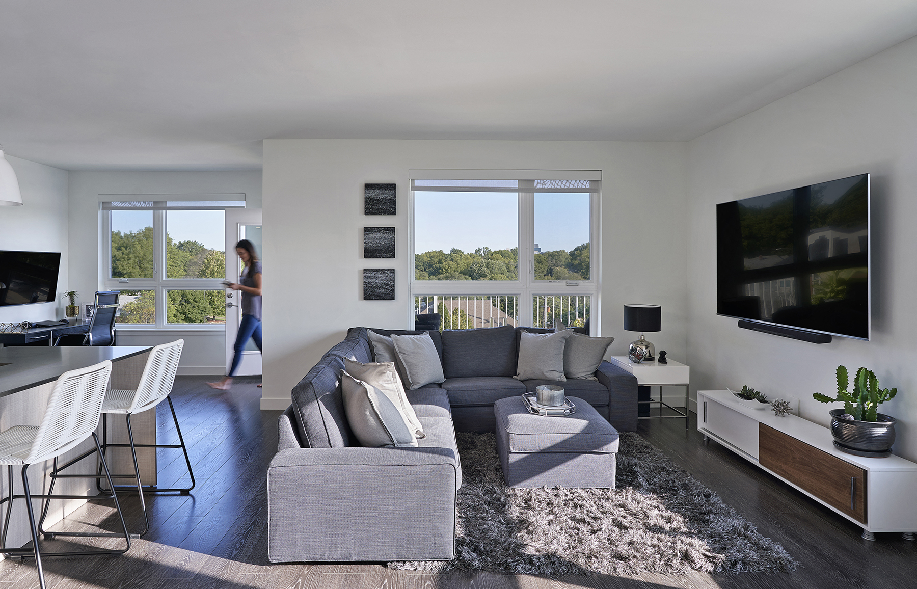 a living room with a gray couch and a large screen tv