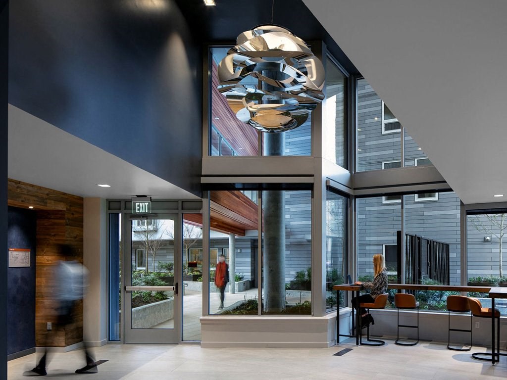 a view of the lobby of a building with large windows