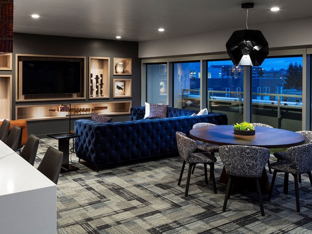 a living room with couches and a table and chairs