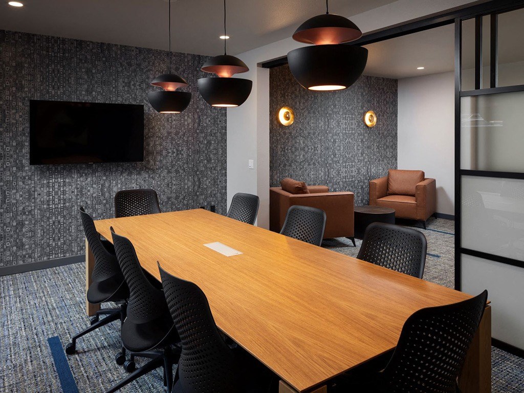 a conference room with a wooden table and chairs