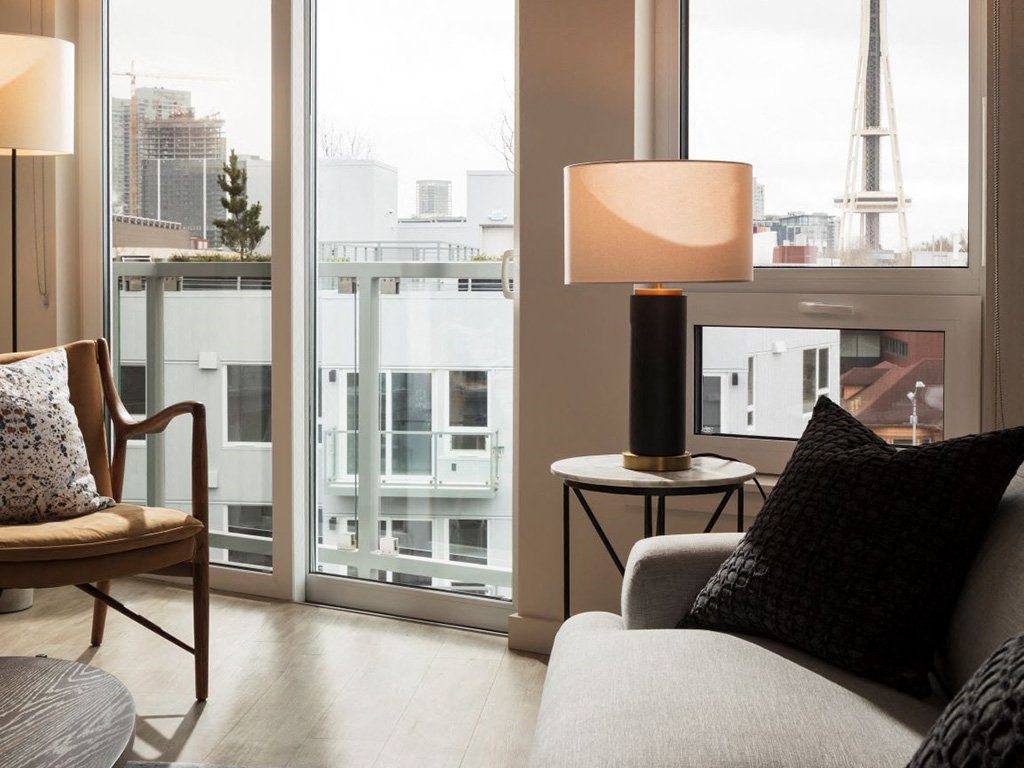 a living room with a couch and a chair and a window