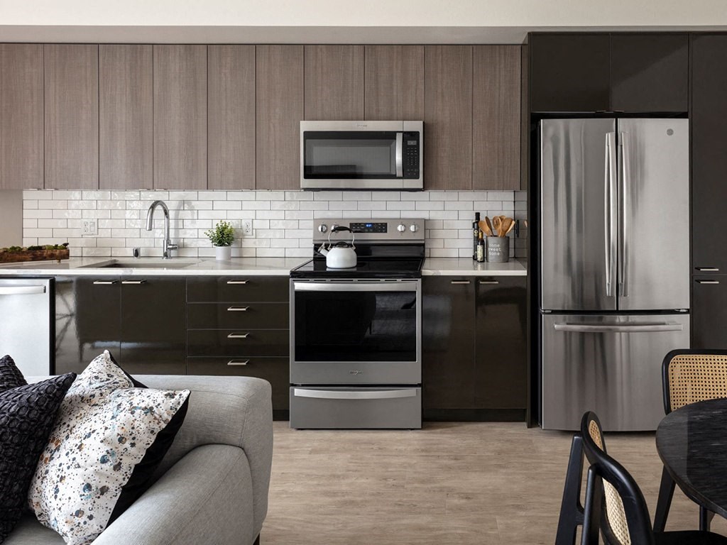 a kitchen with stainless steel appliances and a couch