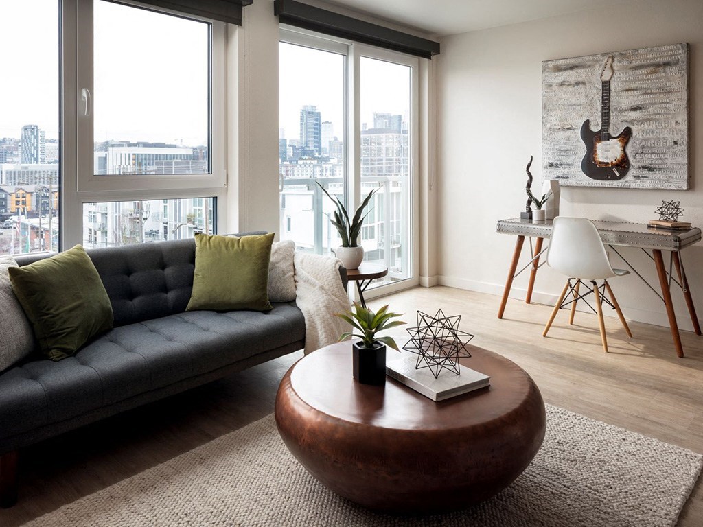 a living room with a couch and a round coffee table