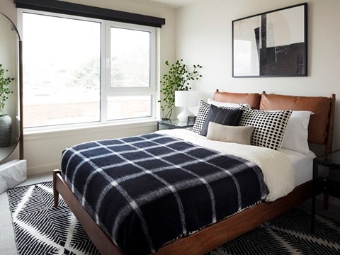 a black and white checkered blanket on a bed in a bedroom
