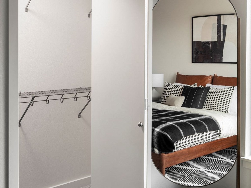 a bedroom with a bed and a mirror