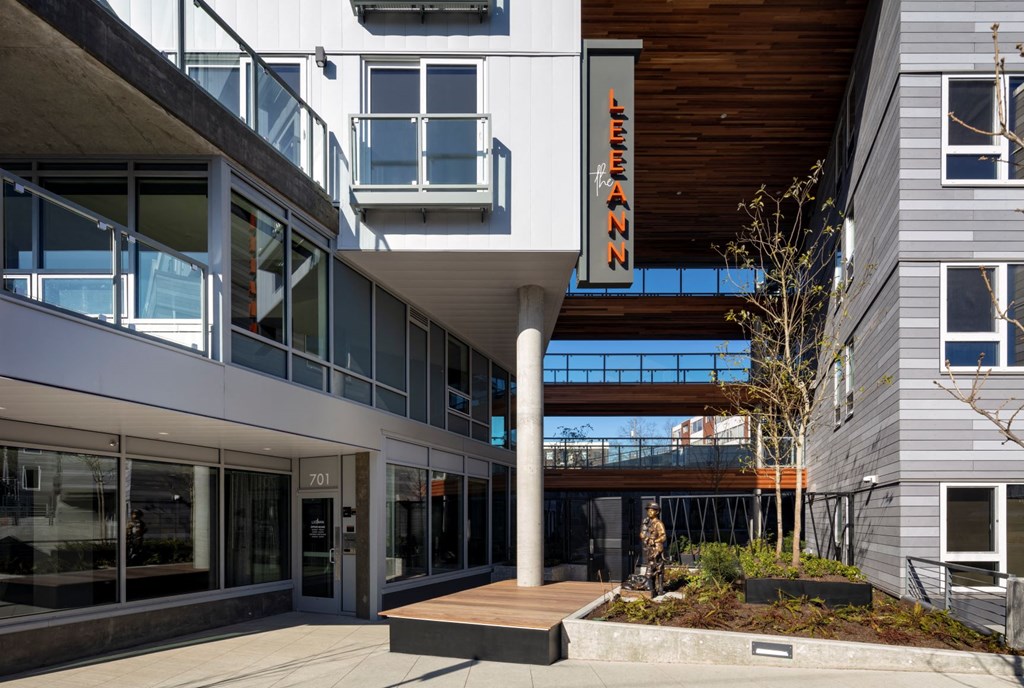 the front entrance of a building with a sign on the side of it