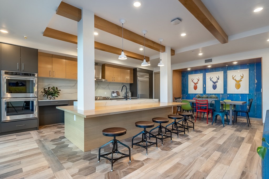 a kitchen with a large island and a table with chairs