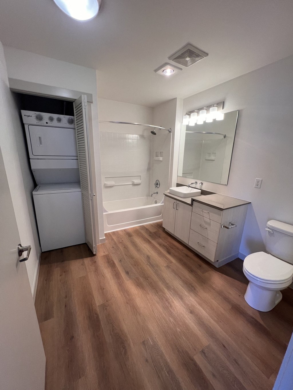 a bathroom with a toilet and a sink and a shower