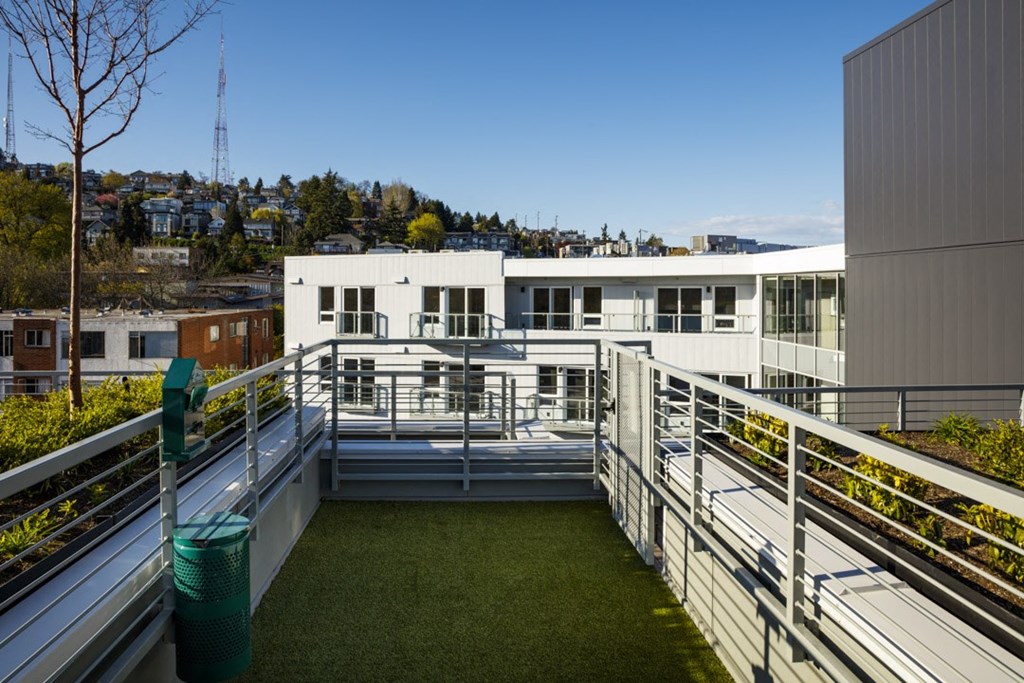 a view of a building from a balcony with grass