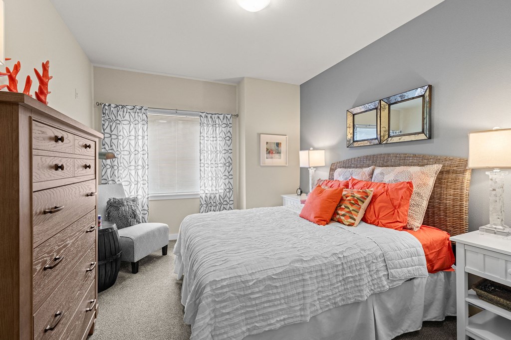 a bedroom with a bed and a dresser