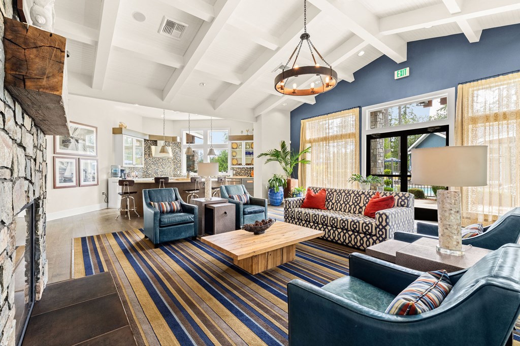 a living room with blue furniture and a fireplace