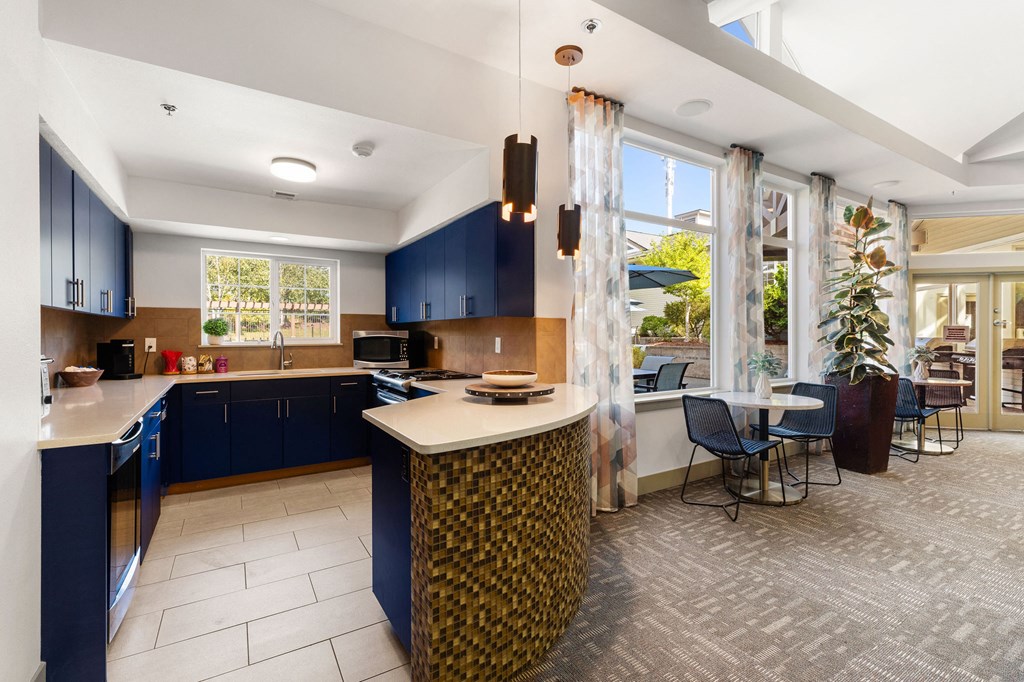 a kitchen with blue cabinets and a table with chairs