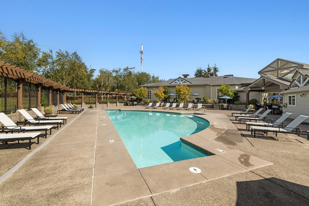 the resort style pool is surrounded by lounge chairs and umbrellas