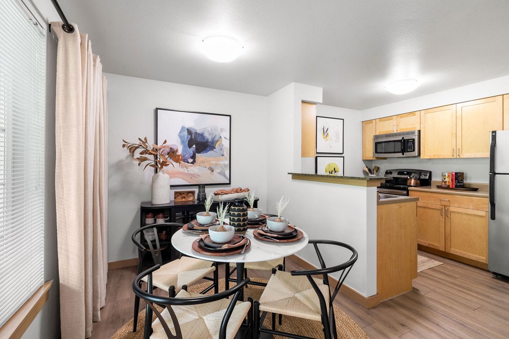 our apartments at the district feature a dining room table and a kitchen