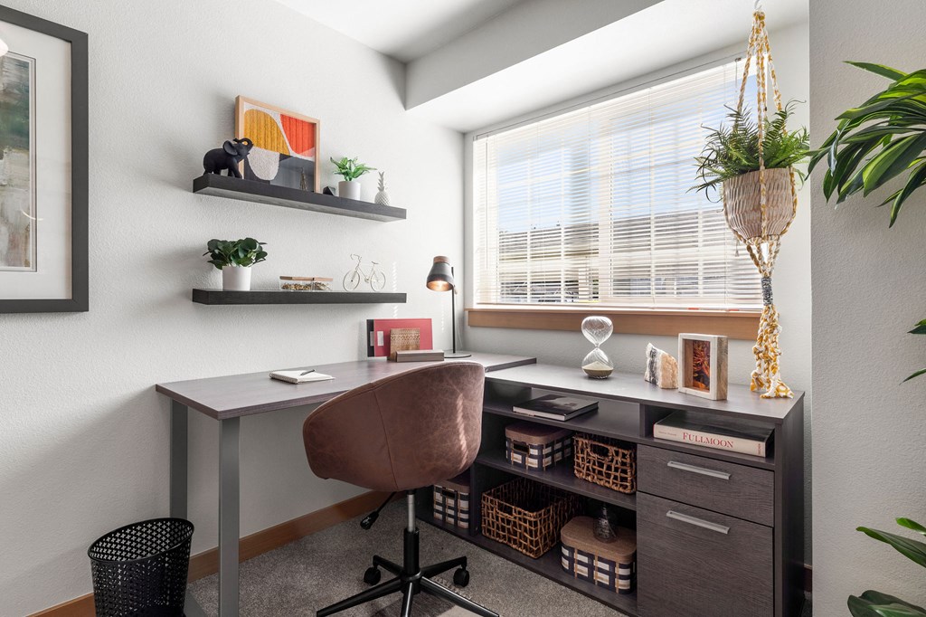 a home office with a desk and a window
