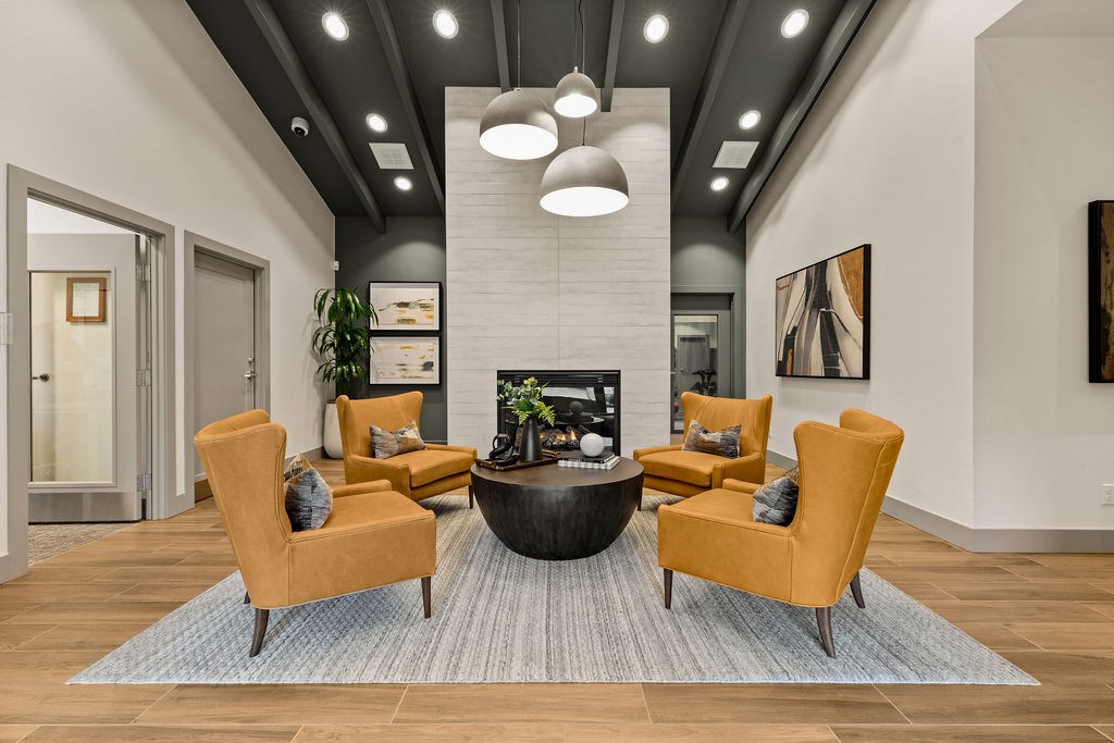 A living room with a fireplace and a coffee table.